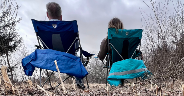 man and woman outside waiting in chairs